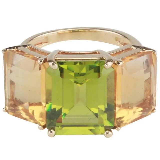 18kt yellow gold Emerald Cut ring with peridot (approximately 5 cts) and citrine (approximately 4 cts each). The ring...