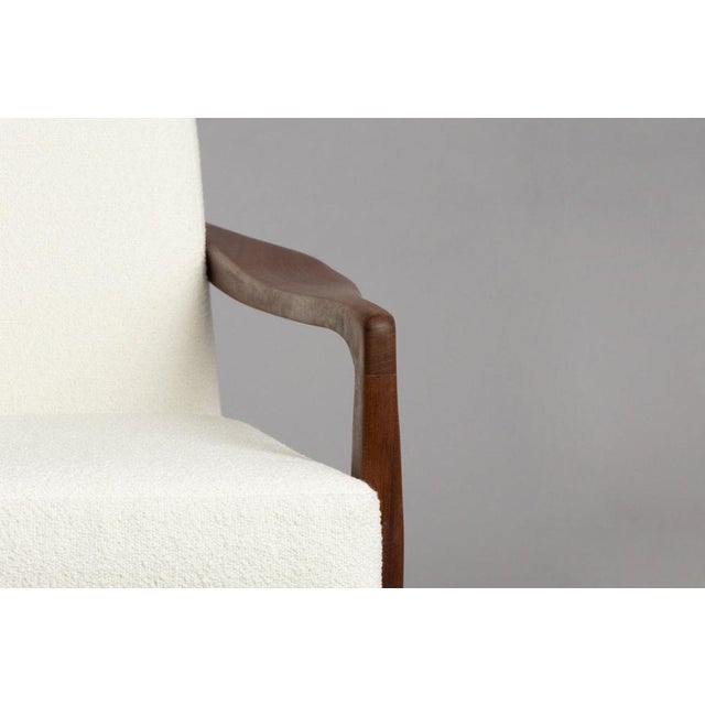 A midcentury three-seater sofa in afromosia by toothill, dating to around the 1960s. The solid timber frame displays the...