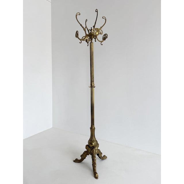 This elegant vintage Italian coat rack from the 1960s combines practical functionality with rich decorative craftsmanship....