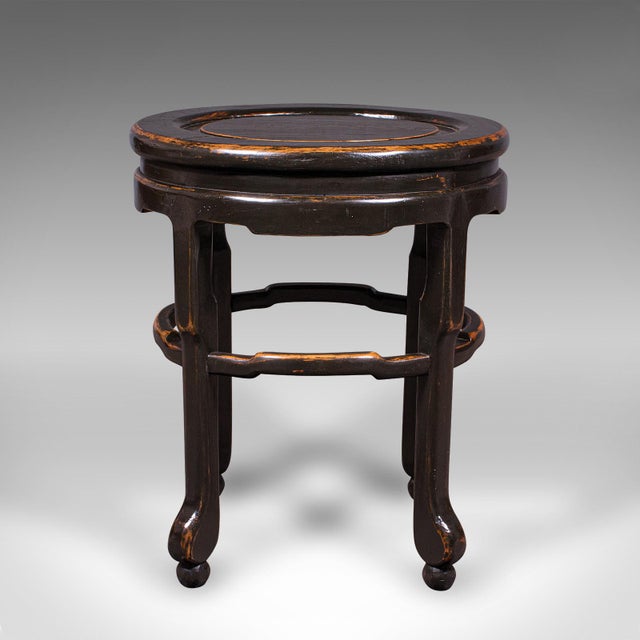 This is an antique oval side table. A Japanese, ebonised elm lamp or wine stand, dating to the late Victorian period,...