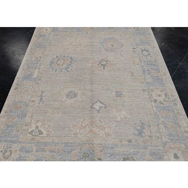 Turkish Oushak Rug Faded Pastel Handwoven Wool Rug 5'1" X 6'10" This 5'1" x 6'10" Turkish Oushak rug showcases a delicate...