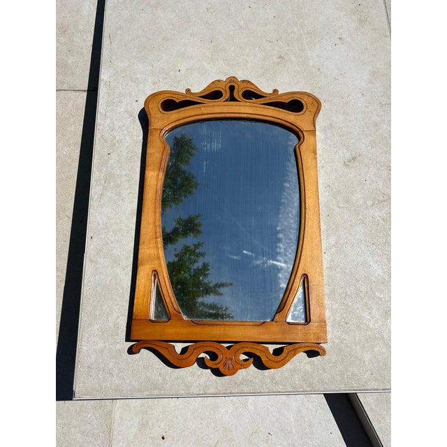 Carved beige wood table mirror, France, 1920s. An elegant table mirror in finely carved light wood, characteristic of...