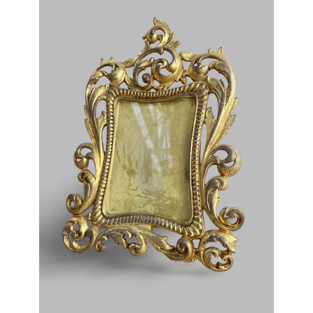 Superb rectangular gilt bronze frame mounted on two cabriole legs with a rear support. The front is richly chased with...