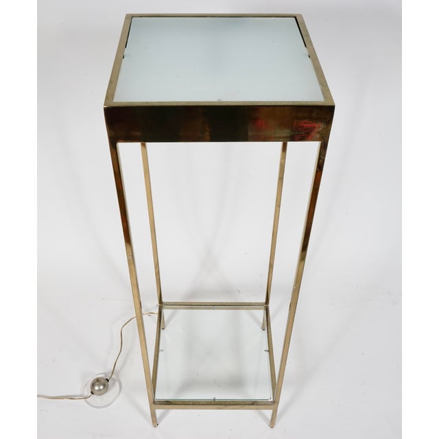 A lighted 2 tier brass display stand or pedestal in the Style of Maison Jansen. Top shelf milk glass, bottom shelf clear...