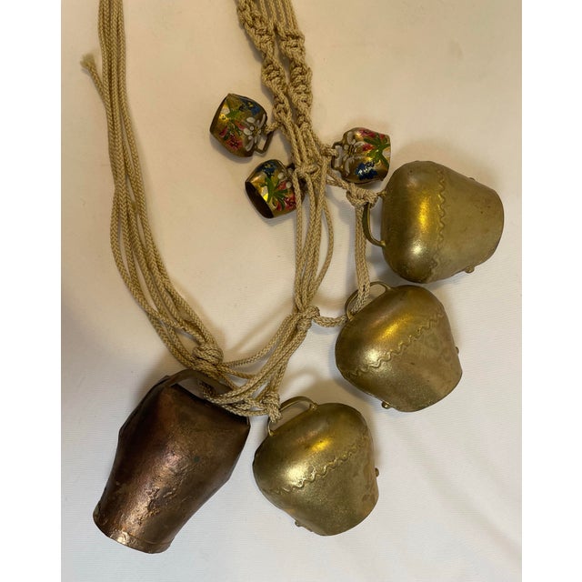 Vintage set of cowbells from the country of Lichtenstein. The three small bells are handpainted with flowers. Hung on a...