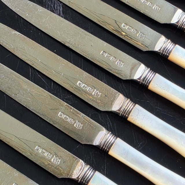 A beautiful antique 31-piece Landers, Frary & Clark / Aetna Works mother-of-pearl handled flatware set with sterling...