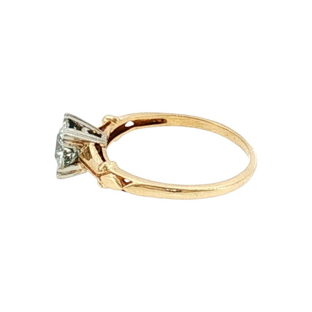 A 1940's refined engagement ring crafted in 14k two-tone gold. The ring showcases a 0.57 carat Old European cut diamond,...