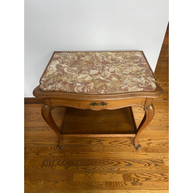 This is a beautiful antique side table, in a medium walnut finish. Very good condition. Cabriole legs. It has one drawer...