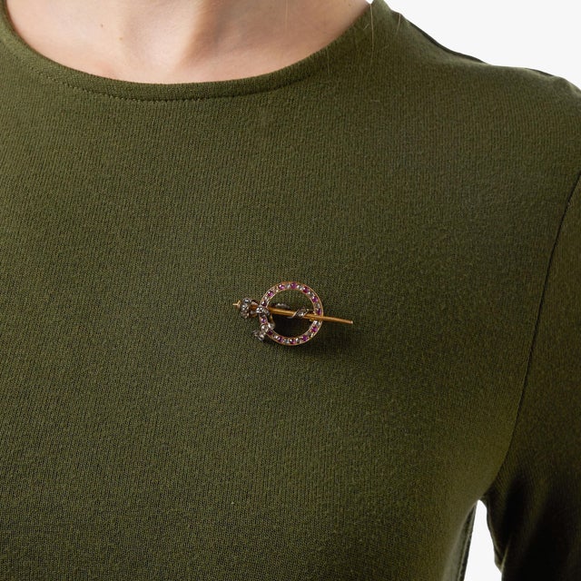 A graceful and beautifully detailed antique brooch from the Victorian era, this elegant piece showcases the delicate...