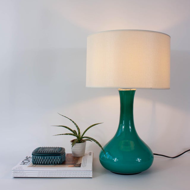 This striking vintage opaline glass table lamp, produced in Portugal during the 1960s, is a beautiful representation of...