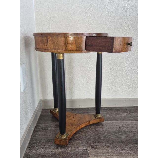 Elegant petite French Empire-style round side table, dating approximately to the 1950s, featuring a solid walnut top,...