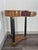 Elegant petite French Empire-style round side table, dating approximately to the 1950s, featuring a solid walnut top,...