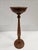 This antique wooden candle stand is approximately 25.75 inches tall, tall enough to be used as a floor stand if desired....