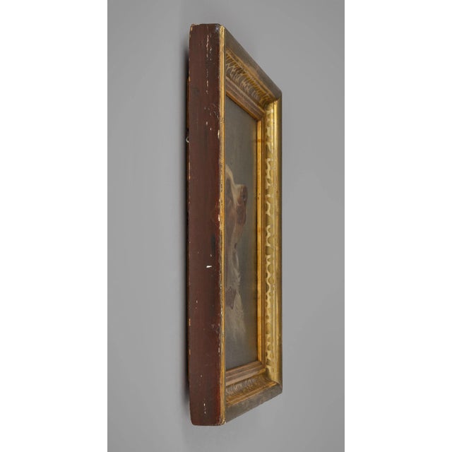 A charming painting of a Cavalier King Charles Spaniel wearing a chestnut and white coat on a dark olive green background....