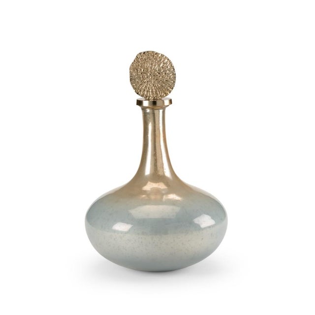 Elegant and contemporary, this genie bottle is crafted of sleek art glass with an ombre finish. The blue, silver and amber...