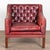20th Century vintage square club chair upholstered in red leather. This handsome chair features a tufted button back and...