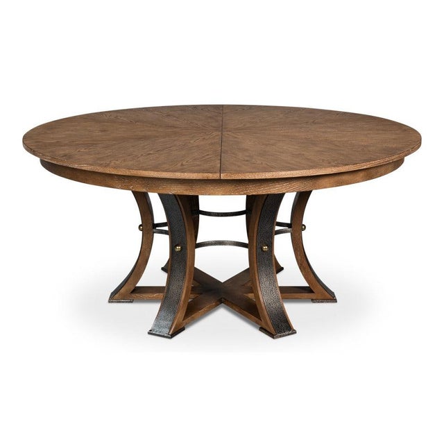 With its light brown oak top and dark hammered iron, this large round dining table has a warm, transitional look. The...