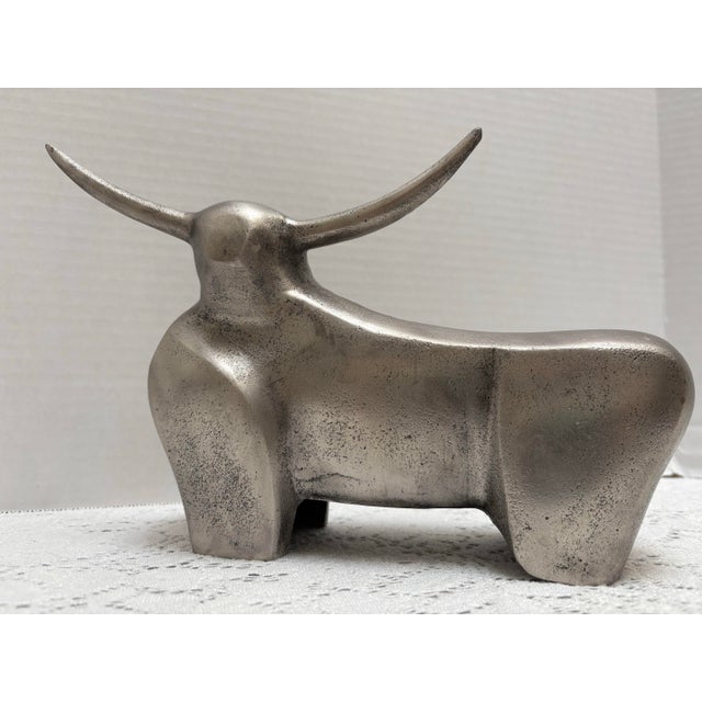 Silver toned chrome or metal bull decor accent. Whimsical retro and classic design.