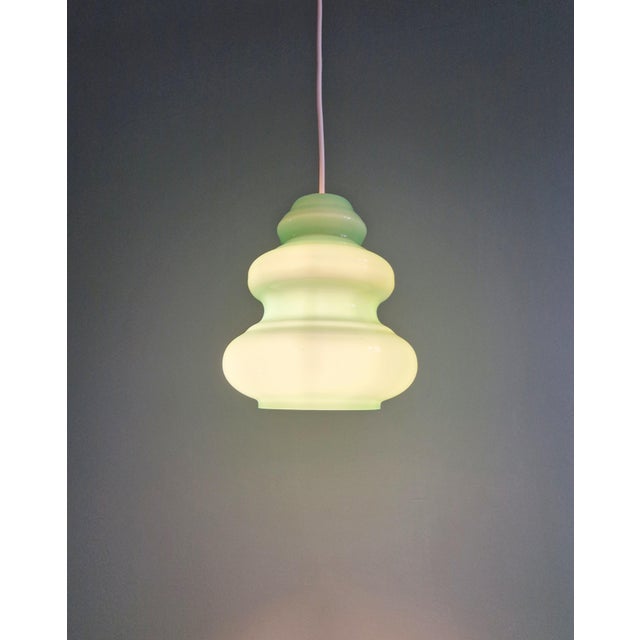 Space Age opaline pendant light with a beautiful blue/green color, 1960s. The pendant light has been restored and is...