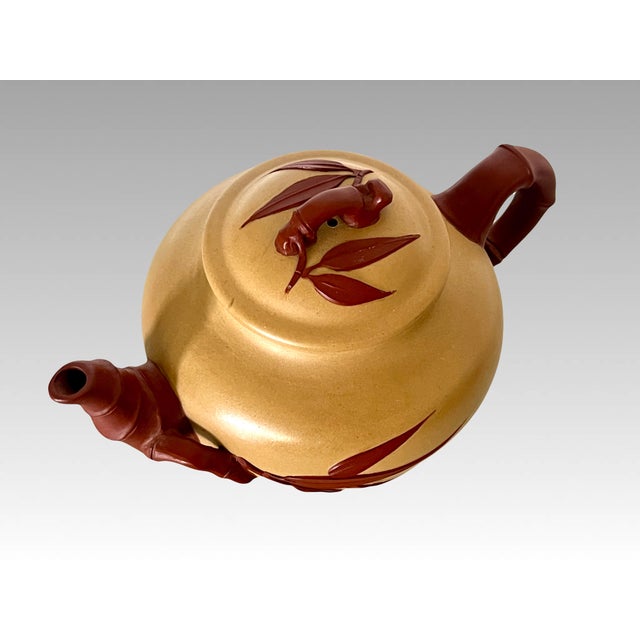 A delightful little signed and chopped Yixing Zisha teapot that design incorporates bamboo leaves & branches.. Very...