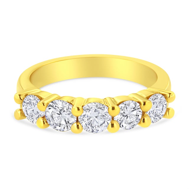 Classic and elegant, this 14k yellow gold plated sterling silver ring is a must have piece. 5 dazzling round cut diamonds...