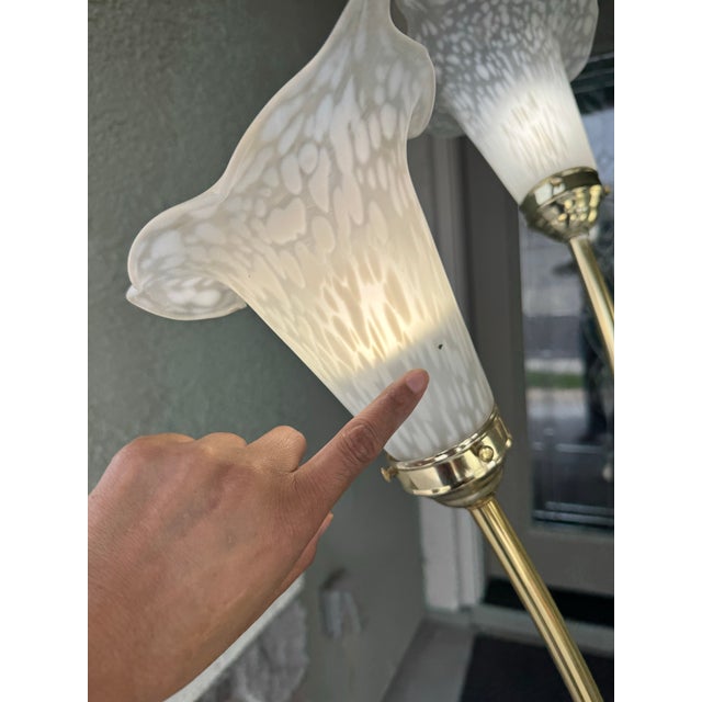 vintage 5-light floor lamp features a polished brass body with stylized calla lily flower shades Missing screw noted in...
