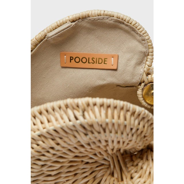 A rattan conch bag designed off of a silver shell statue that the designer's mother had on her bookshelf for the past...