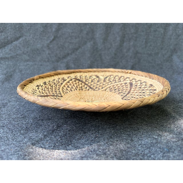 Beautiful intricate design on this Tonga Binga basket. These are woven for the purpose of winnowing grain. This one has a...
