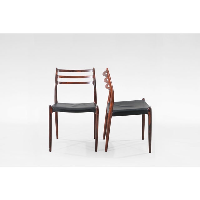 This set of four Model 78 dining chairs, designed by Niels Otto Møller in the 1950s and produced by J.L. Møller...