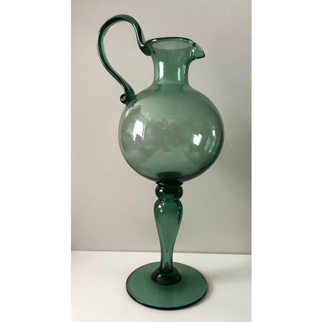A rare and exceptionally sculptural example of Italian Empoli Verde glass, this hand-blown ewer or pitcher combines a...