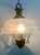 Chandelier made entirely of brass with three E14 lights and white satin glass with a pulegoso effect. Up to 250V...