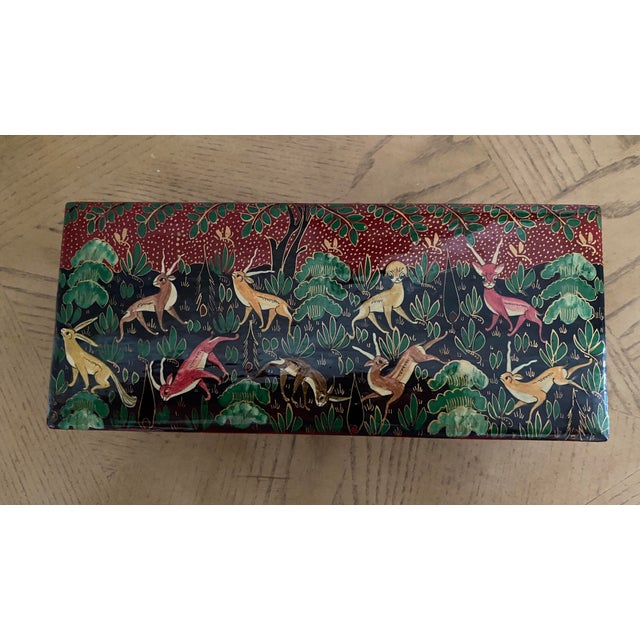 Exquisitely executed paper mache lacquered box featuring foxes and bunny rabbits in a woodland / hunt setting with red and...
