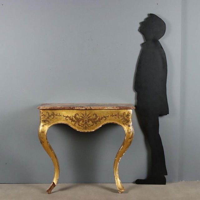 Mid-19th century Italian console, crafted in giltwood. The top is made of 'macchia vecchia' marble, known for its...