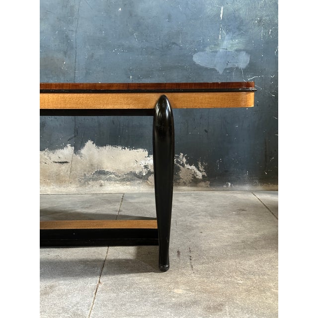 Stunning Italian art deco dining table in the style of Osvaldo Borsani. Bold sculptural design in the black lacquered fin...