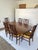 Vintage walnut dining table and six chairs manufactured by Broyhill for the Brasilia collection circa early 1960s. Seldom...
