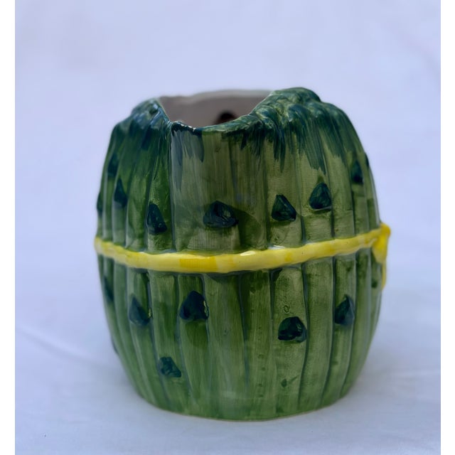 This folk art ceramic pitcher is cleverly disguised as bunch of asparagus tied together with a yellow ribbon. The...