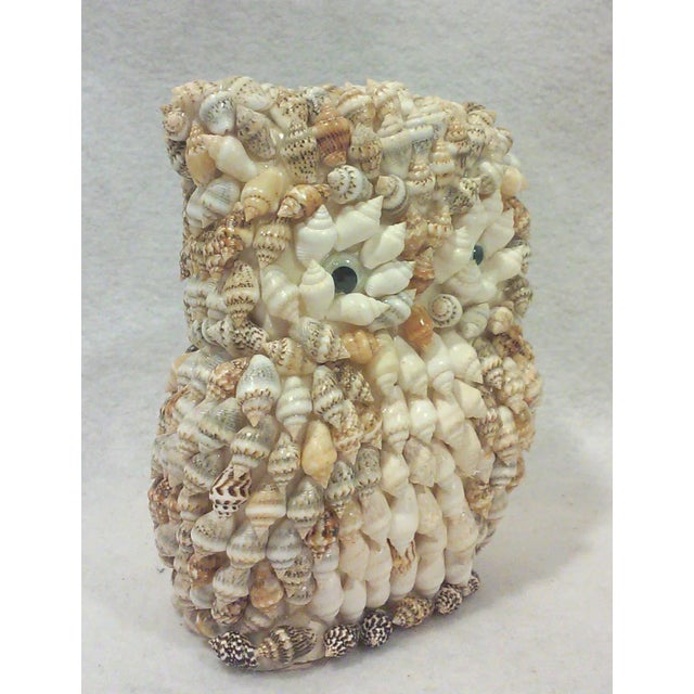 A vintage owl figure covered in tiny shells is a cute desk accessory or fall decor item.