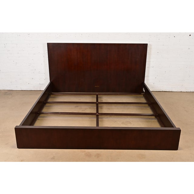 A gorgeous Modern Art Deco mahogany king size bed frame In the manner of Barbara Barry By Ethan Allen Circa Early 21st...