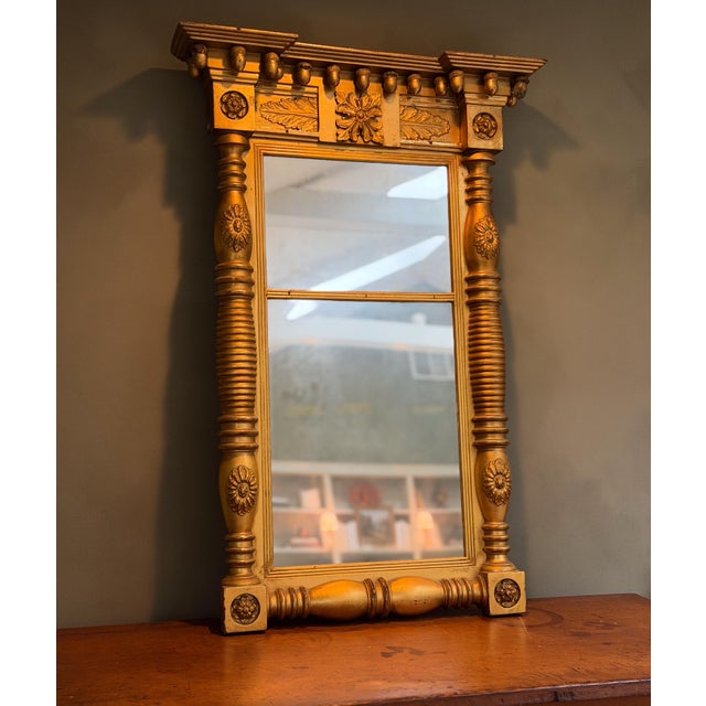 A beautiful split-panel giltwood mirror with interesting provenance! This piece come from the Moss Acre Estate in Maine....