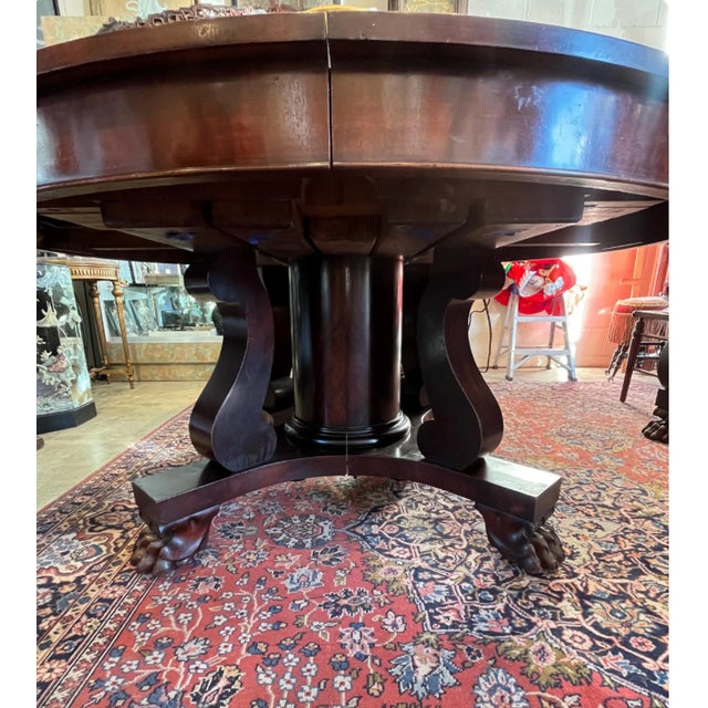 Beautiful Large 1880's Empire Mahogany Dining Table Set with 10 chairs. Split pedestal with large claw feet and 4 leaves....