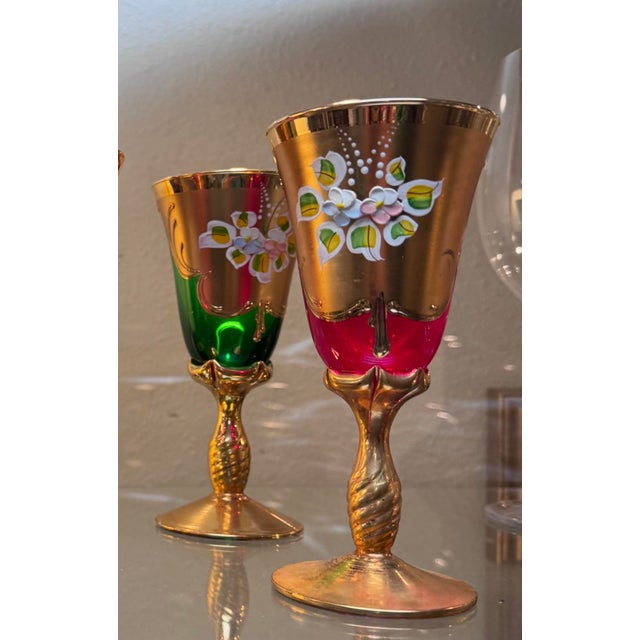 A dazzling set of four vintage Venetian wine glasses, handmade in Italy and presented in four rich jewel tones: cobalt...