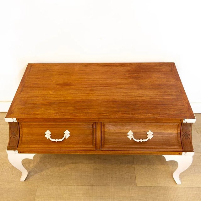 Low coffee table or auxiliar table made of a part of a teak veneer furniture with steel legs. The wood part was completely...