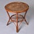 A mid-century side table with a distinct French Riviera aesthetic, circa 1950s. Crafted from honey-toned bent rattan and...