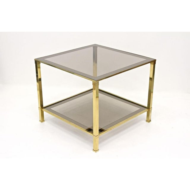 Beautiful late mid century Italian brass side table from the period around 1970. This two-tier Hollywood regency style...