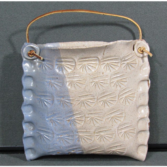 A charming signed handmade studio pottery wall pocket crafted in glazed stoneware, with a soft blue and cream speckled...