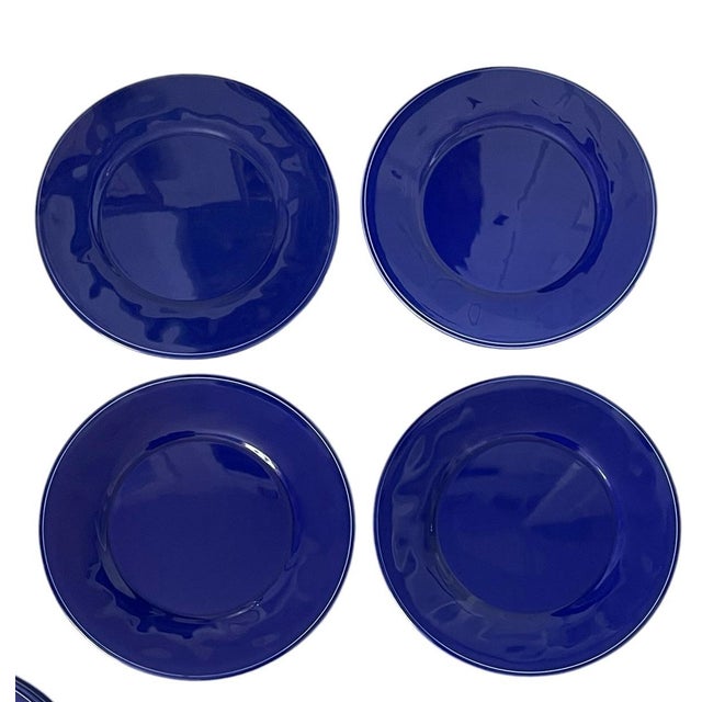 The product is a set of 8 Williams Sonoma Service Charger Chop Plates in navy blue, measuring 13 inches in diameter. Made...