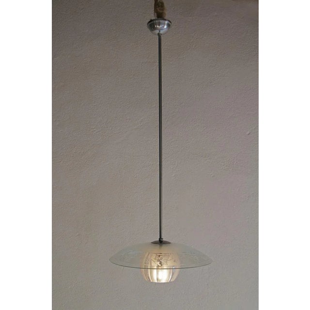 Italian Mid-Century Modern pendant lamp attributed to Stilnovo fashion house, from 1950. This pendant lamp is made from...
