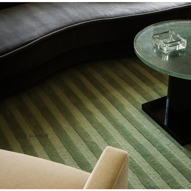 The Pistachio Lines Textured Wool Rug is a refined blend of softness and modern design. Hand-tufted from 100% premium New...