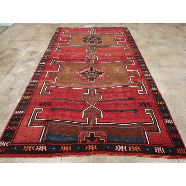 A vintage Turkish Anatolian long room size carpet handmade during the Mid-20th Century. Measures: 8' 3" x 14' 10".