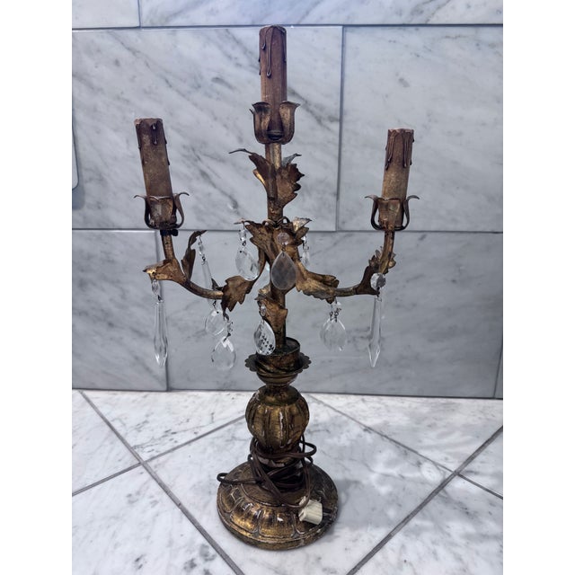 Italian Style Gilt Wood and Metal Three Light Candelabra Has hanging drop prisms and featuring tole acanthus leaf...